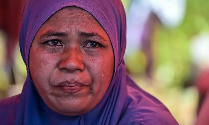 Siti Saudah Daso, a mother of three, reacts while sheltering under a tent in an open field in Mbay, Nagekeo, East Nusa Tenggara, on August 17, 2026. &mdash; AFP