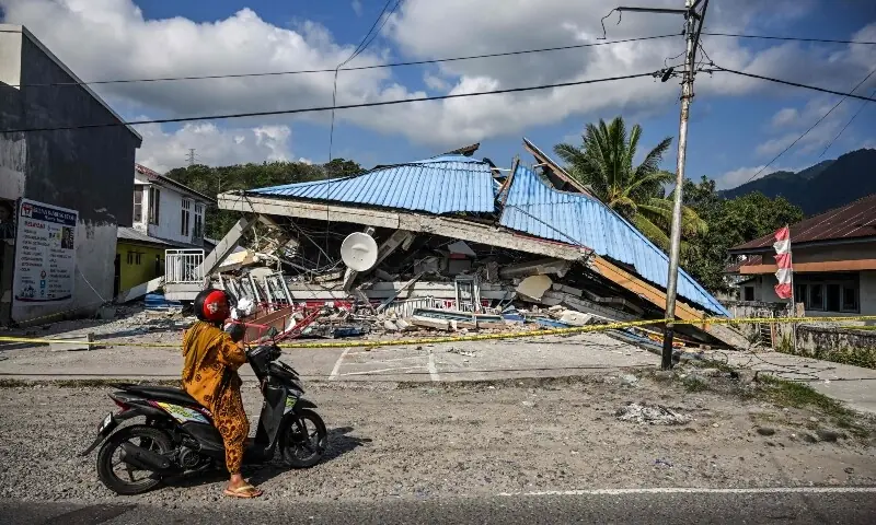 A motorbike stops next to a collapsed building following a 7.7-magnitude earthquake in Borong, East Manggarai, East Nusa Tenggara on August 16, 2026. &mdash; AFP