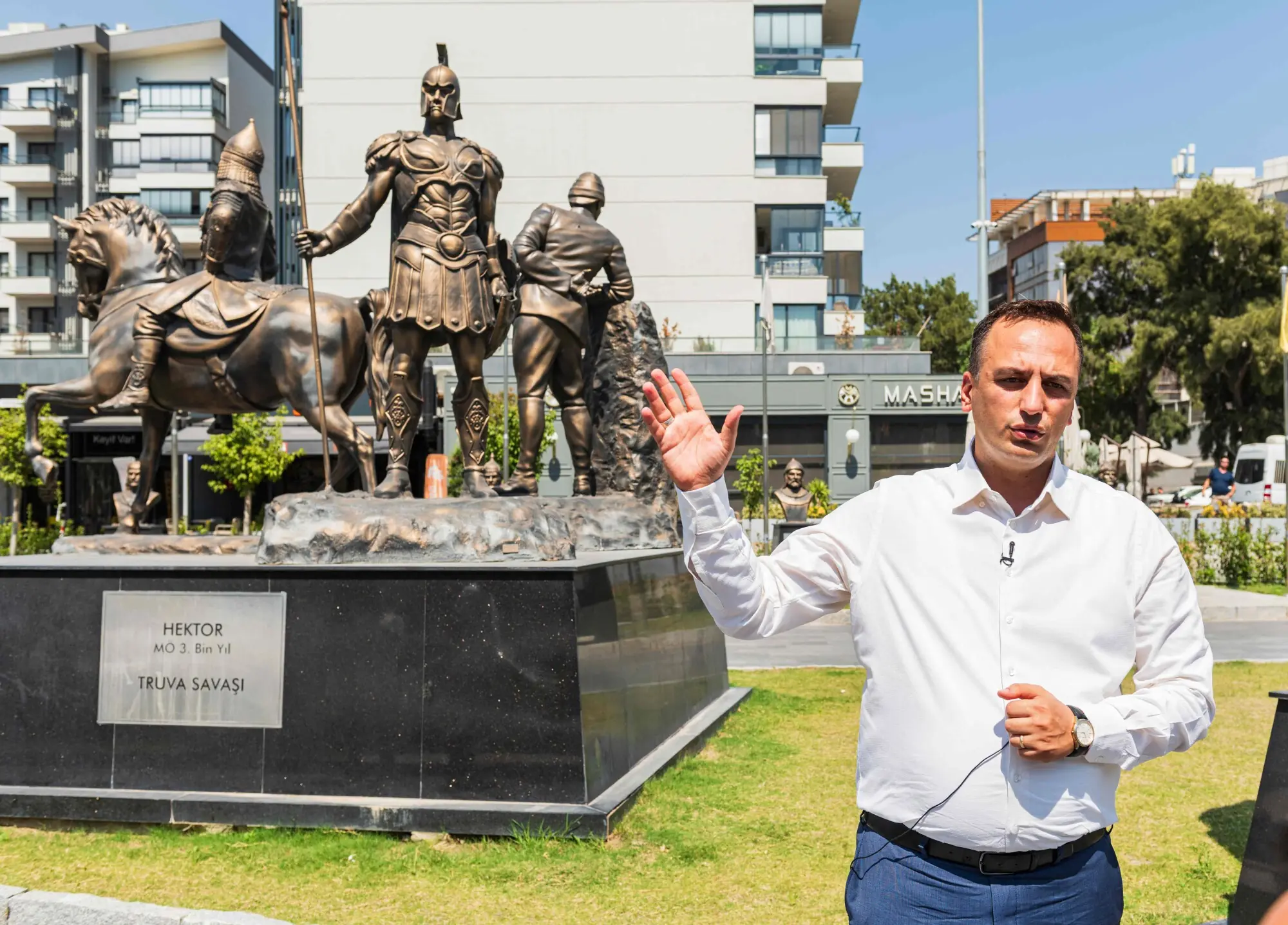 Bornova Mayor Ömer Eşki speaking in front of the town’s statue of Hector.