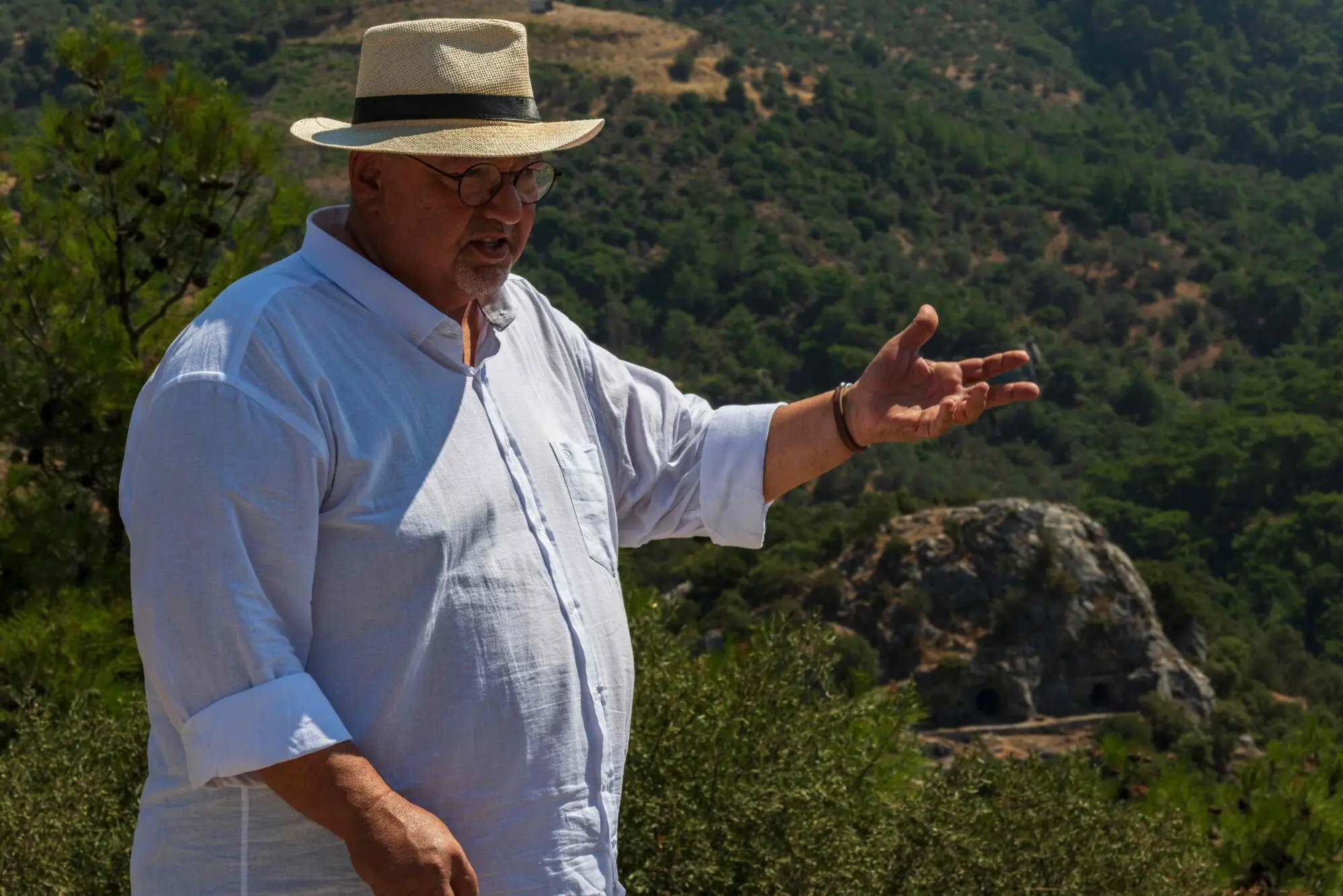 Historian Altan Altin gestures at the cave Homer is said to have penned The Odyssey in.