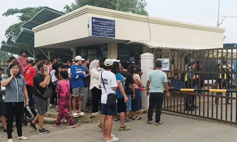 People stand outside Ateneo de Zamboanga University after a shooting that killed two people, in Zamboanga, southern Philippines, August 18, 2026. —Reuters People stand outside Ateneo de Zamboanga University after a shooting that killed two people, in Zamboanga, southern Philippines, August 18, 2026. —Reuters