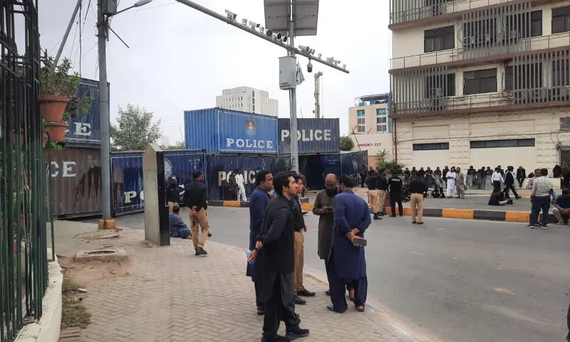 Lawyers sit in the road near containers installed to barricade Dr Ziauddin Ahmed Rd in Karachi on August 20. &mdash; via Mikail Ahmed Shaikh