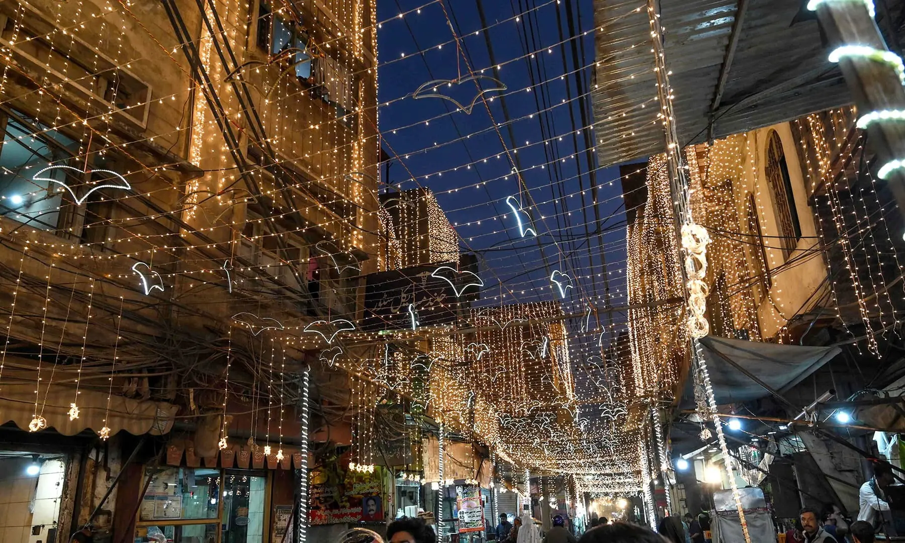 People walk in a decorated street to mark the biirth of the Prophet Mohammed, in Lahore on November 9, 2019. — AFP/File People walk in a decorated street to mark the biirth of the Prophet Mohammed, in Lahore on November 9, 2019. — AFP/File