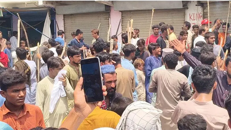 ENRAGED tenants pose resistance as Larkana municipality officials seal their shops to vacate the space for a PBS bus terminal, on Friday.—Dawn ENRAGED tenants pose resistance as Larkana municipality officials seal their shops to vacate the space for a PBS bus terminal, on Friday.—Dawn