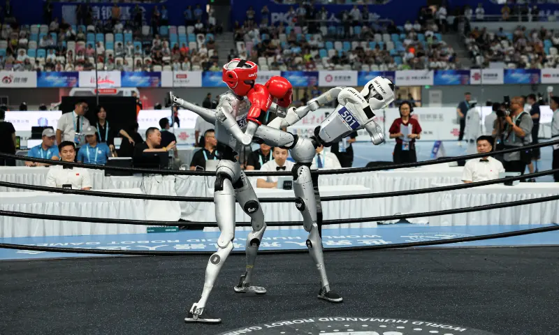 Humanoid robots by Unitree Robotics compete in the 80 kg class kickboxing quarterfinals during 2026 World Humanoid Robot Games, at the National Speed Skating Oval, in Beijing, China on August 23, 2026. &mdash; Reuters