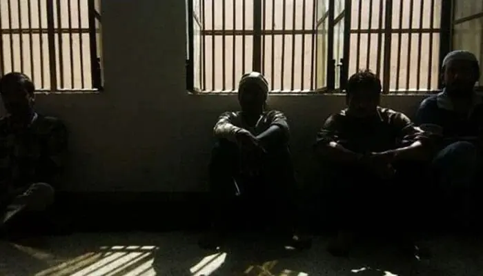 Prisoners sitting inside a dark lockup are seen in this undated image. &mdash; AFP/File