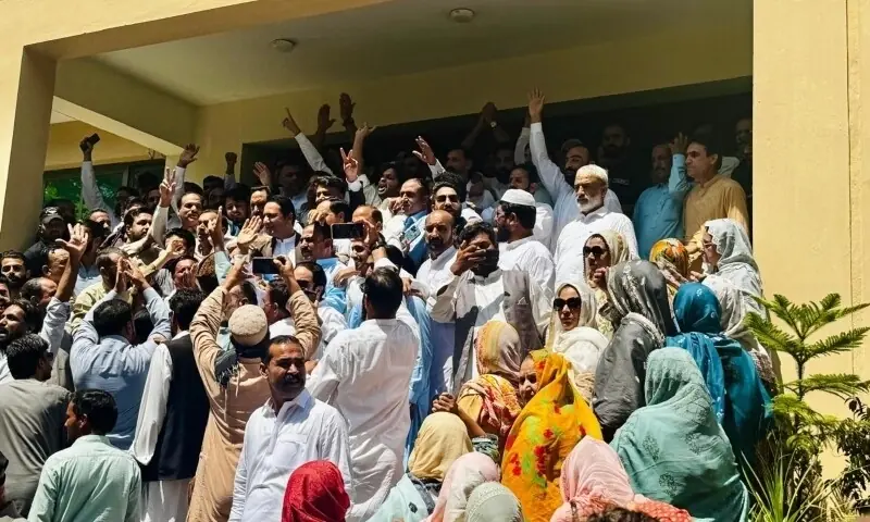 Barrister Iftikhar Ali Gillani, PML-N candidate for the reserved seat for technocrats and other professionals, waves to his cheerful supporters at the entrance of the AJK Legislative Assembly after the announcement of results. &mdash; Photo by Tariq Naqash