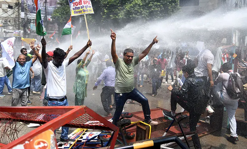 DEMONSTRATORS shout slogans as police use water cannons to disperse them during the protest in Patna, Bihar.—Reuters DEMONSTRATORS shout slogans as police use water cannons to disperse them during the protest in Patna, Bihar.—Reuters