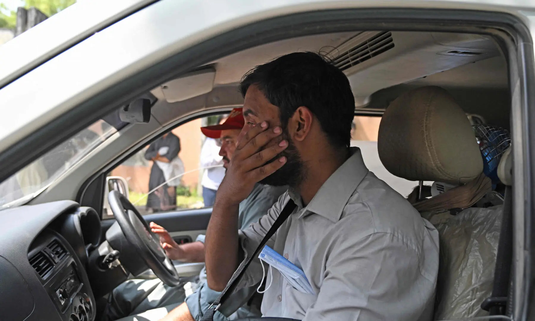 A grieving father reacts as his child&rsquo;s coffin is transported in an ambulance following a fire outside the Mother and Child Health (MCH) ward at the Pakistan Institute of Medical Sciences (PIMS) Hospital in Islamabad on August 26, 2026. &mdash; AFP