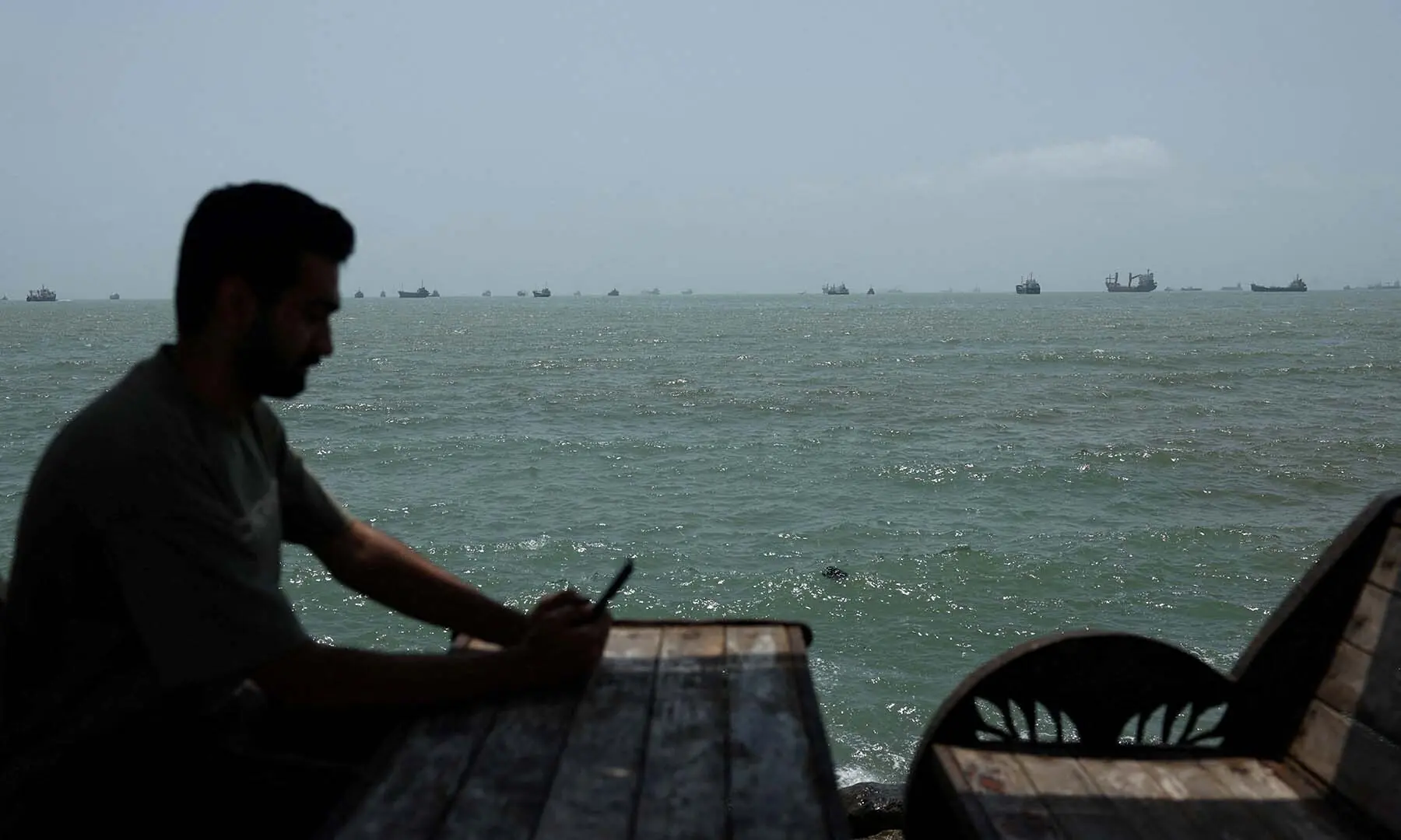 Vessels in the Strait of Hormuz are visible from the beach at Bandar Abbas, Iran on August 26, 2026. &mdash; Reuters