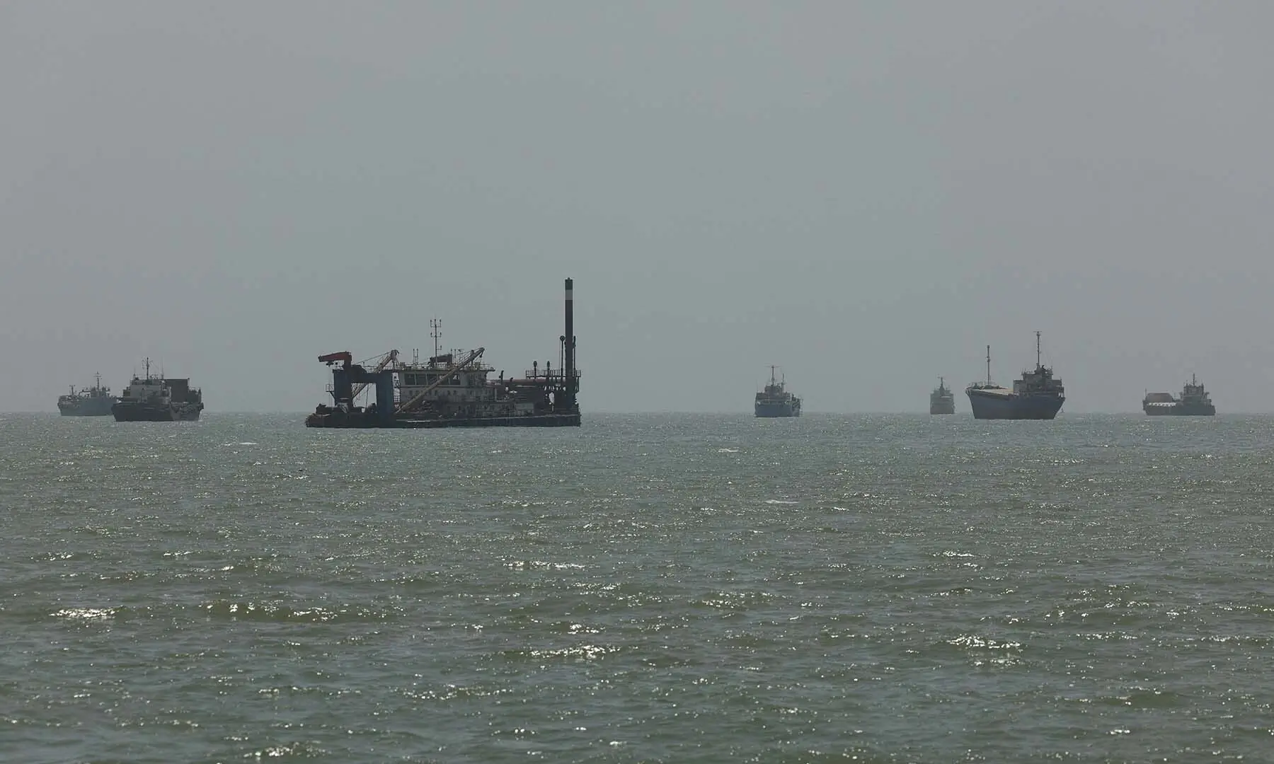 Vessels in the Strait of Hormuz are visible from the beach at Bandar Abbas, Iran on August 26, 2026. &mdash; Reuters