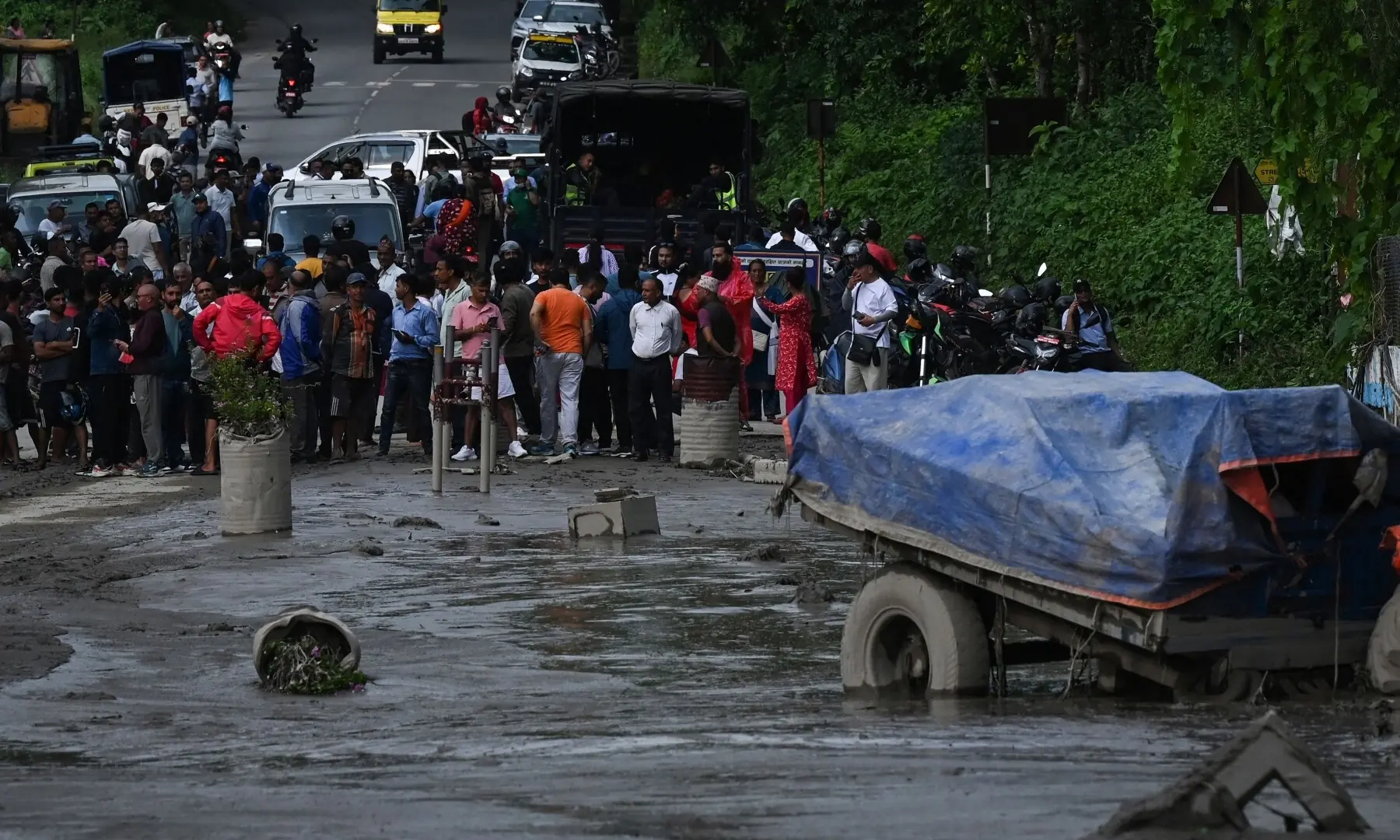 Residents look at a street submerged by mud following flash floods and a landslide disaster in Devighat, in Nepal&rsquo;s Nuwakot district on August 26, 2026. &mdash;AFP