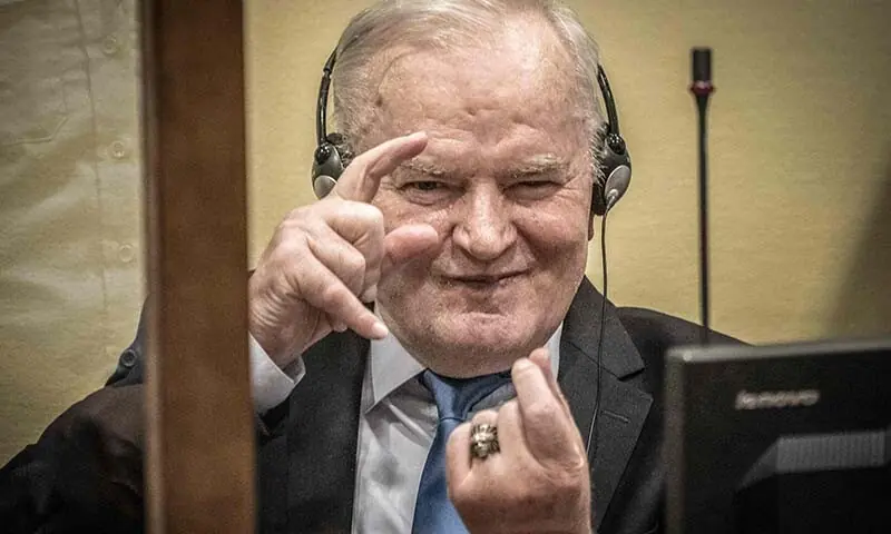 Ex-Bosnian Serb military chief Ratko Mladic imitates taking pictures as he sits in the defendant box prior to the hearing of the final verdict on appeal against his genocide conviction over the 1995 Srebrenica massacre, on June 8, 2021 at the International Residual Mechanism for Criminal Tribunals (IRMCT) in The Hague, the Netherlands. — AFP Ex-Bosnian Serb military chief Ratko Mladic imitates taking pictures as he sits in the defendant box prior to the hearing of the final verdict on appeal against his genocide conviction over the 1995 Srebrenica massacre, on June 8, 2021 at the International Residual Mechanism for Criminal Tribunals (IRMCT) in The Hague, the Netherlands. — AFP