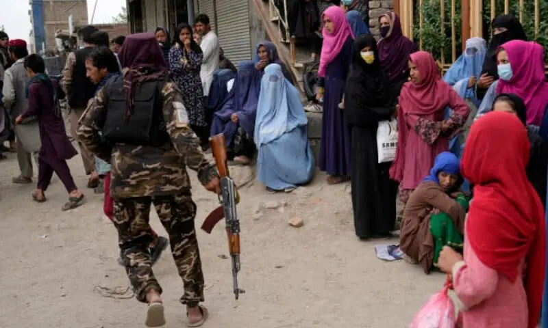 A Taliban fighter stands guard as people wait to receive food rations distributed by a South Korean humanitarian aid group, in Kabul, Afghanistan, May 10, 2022. —AFP/File A Taliban fighter stands guard as people wait to receive food rations distributed by a South Korean humanitarian aid group, in Kabul, Afghanistan, May 10, 2022. —AFP/File