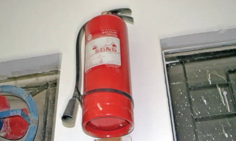 An outdated fire extinguisher hangs on a wall at Islamabad Model College for Boys, G-10. --Dawn/File