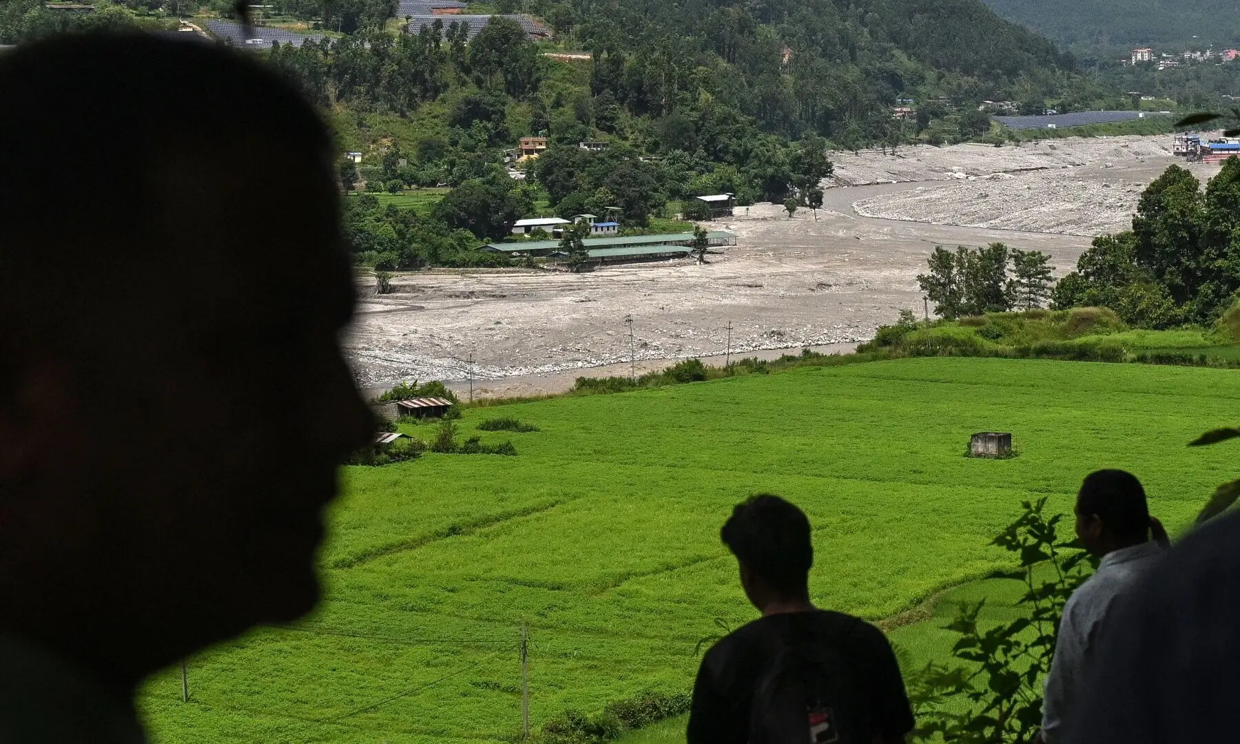 Residents look at the Trishuli River as they take shelter at an elevated place after a flood warning in the Pipaltar area of Nepal&rsquo;s Nuwakot district on August 28, 2026. &mdash; AFP
