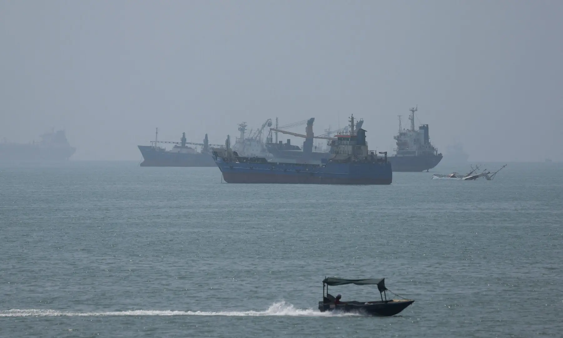 Vessels in the Strait of Hormuz are visible near the beach of Bandar Abbas, Iran on August 28, 2026. &mdash; Reuters