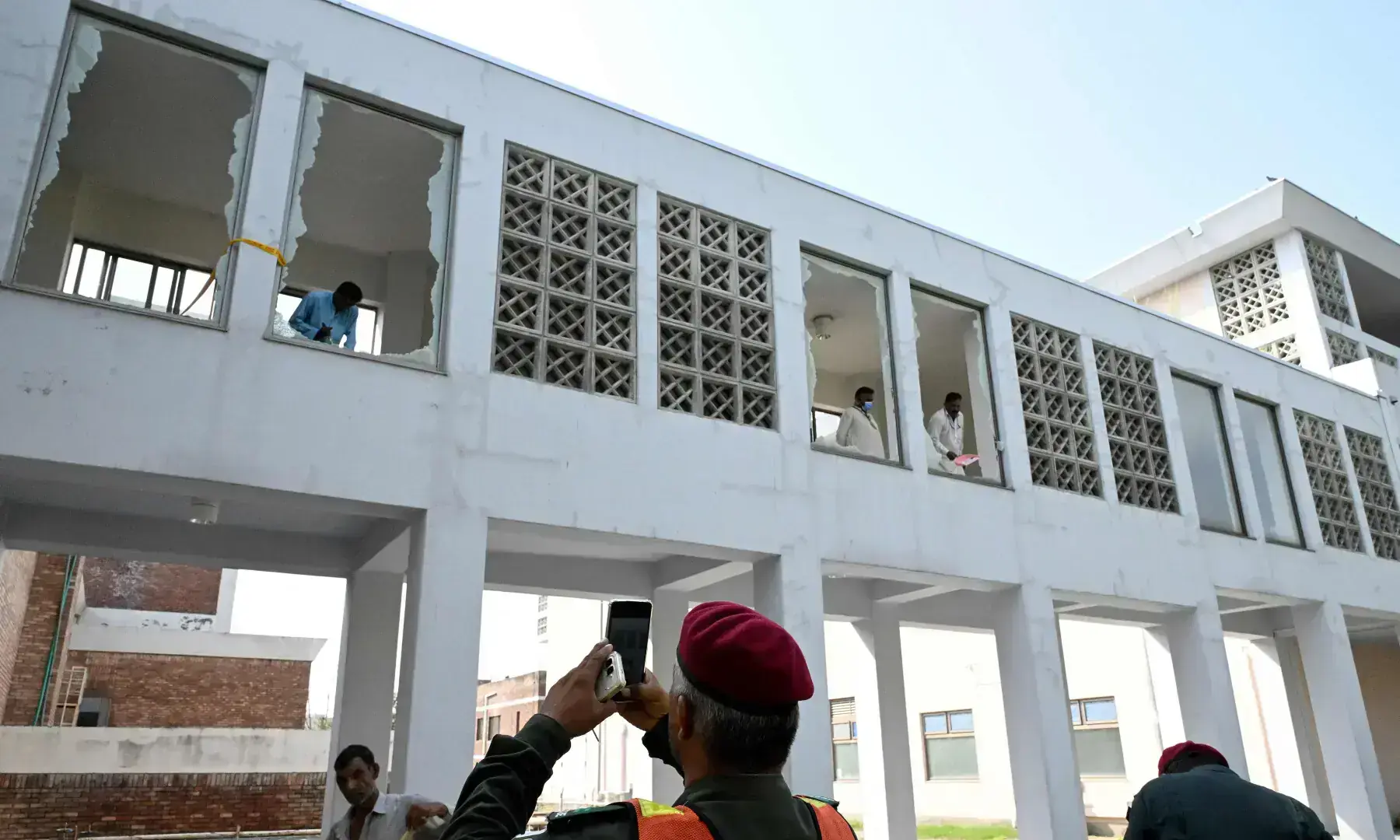 Workers remove shards of broken windows following a fire incident outside the Mother and Child Health (MCH) ward at the Pakistan Institute of Medical Sciences (PIMS) Hospital in Islamabad on Aug 26, 2026. — AFP Workers remove shards of broken windows following a fire incident outside the Mother and Child Health (MCH) ward at the Pakistan Institute of Medical Sciences (PIMS) Hospital in Islamabad on Aug 26, 2026. — AFP