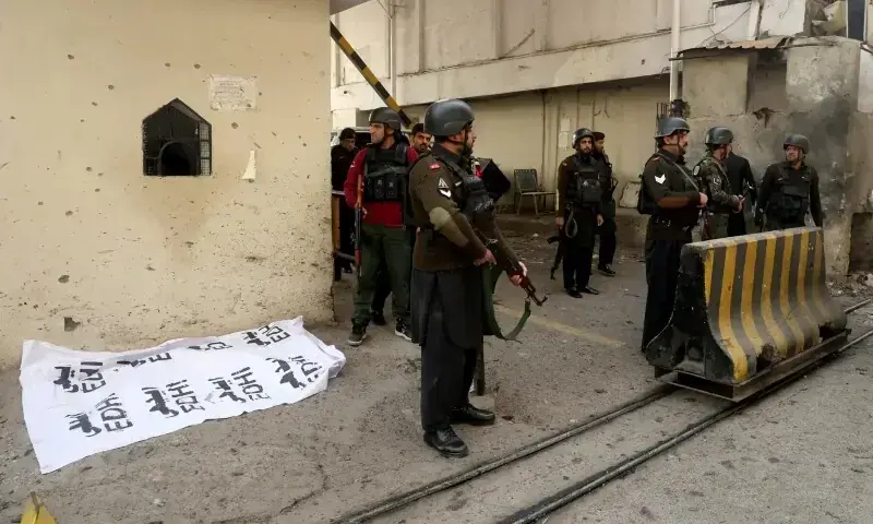 Paramilitary soldiers stand near a body covered with a sheet, after suicide bombers targeted the Federal Constabulary headquarters in Peshawar on November 24, 2025. — Reuters/File Paramilitary soldiers stand near a body covered with a sheet, after suicide bombers targeted the Federal Constabulary headquarters in Peshawar on November 24, 2025. — Reuters/File