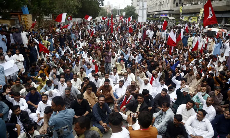Participants of the march listen to speeches of their leaders outside the Karachi Press Club.&mdash;Shakil Adil / White Star