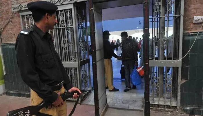 In this representational image, Pakistan Railway police personnel check passengers at the railway station entrance. &mdash; AFP/File