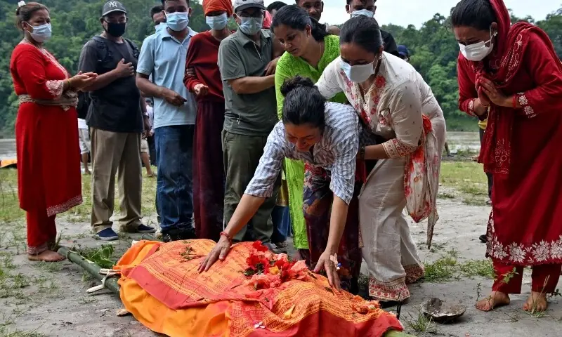Ayush Khadka&rsquo;s mother Monac Khadka mourns during her son&rsquo;s cremation in the aftermath of flash floods, in Nepal&rsquo;s Chitwan district on August 31, 2026. &mdash;AFP