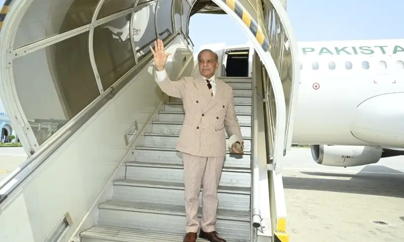 Prime Minster Shehbaz Sharif gestures as departs on an official visit to Kyrgyzstan on Aug 31. &mdash; Photo courtesy @PakPMO/X
