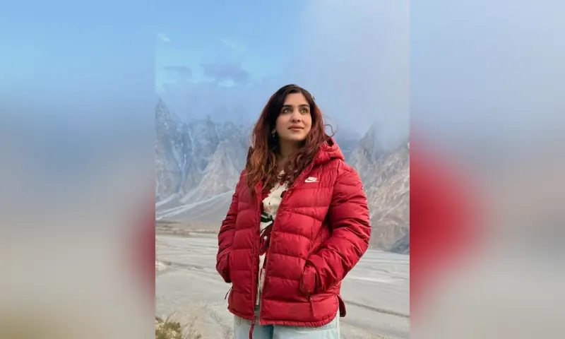 Asma Mushtaq, a 34-year-old climber who died while descending from Gilgit-Baltistan's Spantik Peak on Aug 20, poses in front of a mountain range. &mdash; photo courtesy: drasma.explores via Instagram