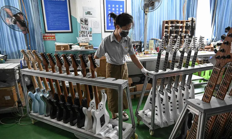 AN employee works on a guitar production line at a factory in Zheng&rsquo;an, south-western China.&mdash;AFP