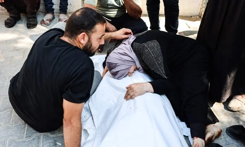 A Palestinian woman grieves over the shrouded body of one of several victims of an Israeli airstrike that targeted a vehicle, as the bodies are taken for burial from the al-Shiffa Hospital in Gaza City, on August 31, 2026. — AFP A Palestinian woman grieves over the shrouded body of one of several victims of an Israeli airstrike that targeted a vehicle, as the bodies are taken for burial from the al-Shiffa Hospital in Gaza City, on August 31, 2026. — AFP