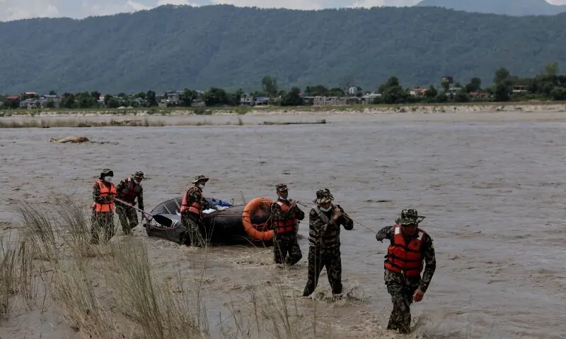 Members of the Nepal Army head back after collecting the bodies that were washed away by flash floods and a mudslide, in Narayani River, Chitwan, Nepal, August 31, 2026. — Reuters Members of the Nepal Army head back after collecting the bodies that were washed away by flash floods and a mudslide, in Narayani River, Chitwan, Nepal, August 31, 2026. — Reuters