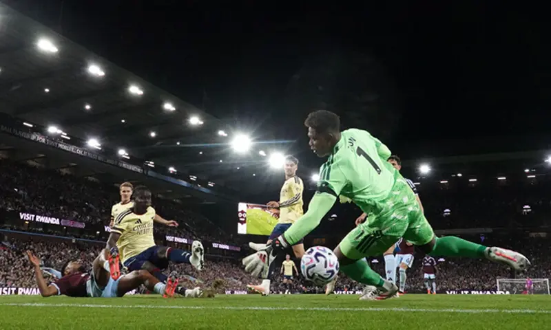 ARSENAL’S Bukayo Saka (second L) scores past Aston Villa goalkeeper Zion Suzuki during their Premier League match at Villa Park.—Reuters ARSENAL’S Bukayo Saka (second L) scores past Aston Villa goalkeeper Zion Suzuki during their Premier League match at Villa Park.—Reuters