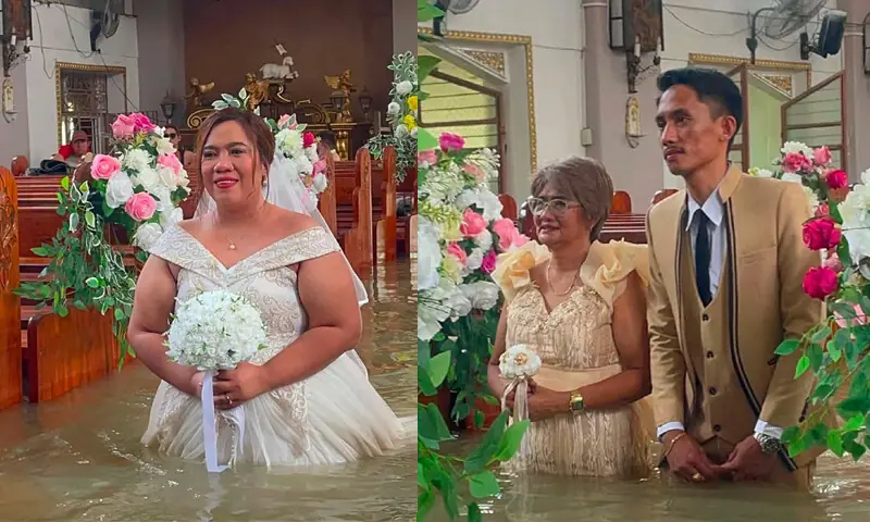 BRIDE Leian Lieza Galang and groom Gilbert Gibo make their way down a submerged aisle during their wedding ceremony in a flooded church.— AFP BRIDE Leian Lieza Galang and groom Gilbert Gibo make their way down a submerged aisle during their wedding ceremony in a flooded church.— AFP