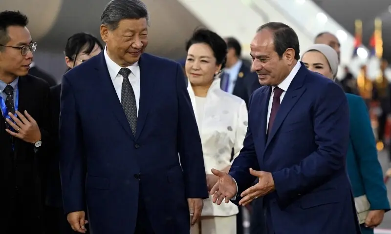 China's President Xi Jinping (2L) listens to his Egyptian counterpart Abdel Fattah al-Sisi (R) as Xi's wife Peng Liyuan (C) watches upon their arrival at the Cairo International Airport on September 1, 2026. &mdash;AFP