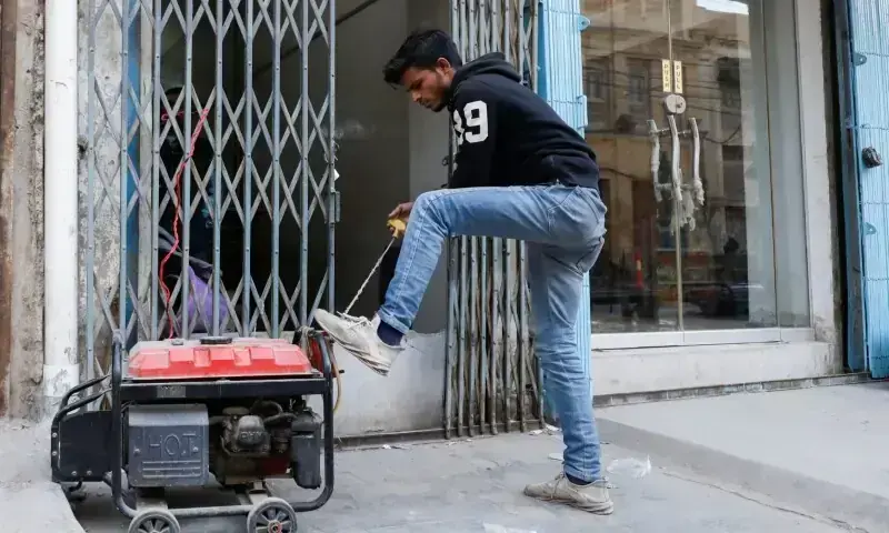 A man starts a generator outside his shop during a country-wide power breakdown in Karachi on January 23, 2023. — Reuters/File A man starts a generator outside his shop during a country-wide power breakdown in Karachi on January 23, 2023. — Reuters/File