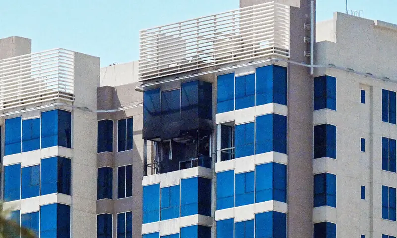 KUWAIT CITY: Damage to a residential building is visible following what Kuwaiti authorities claimed was an Iranian drone attack, as Tehran targeted US military bases in Kuwait, despite Trump’s threats.—AFP KUWAIT CITY: Damage to a residential building is visible following what Kuwaiti authorities claimed was an Iranian drone attack, as Tehran targeted US military bases in Kuwait, despite Trump’s threats.—AFP