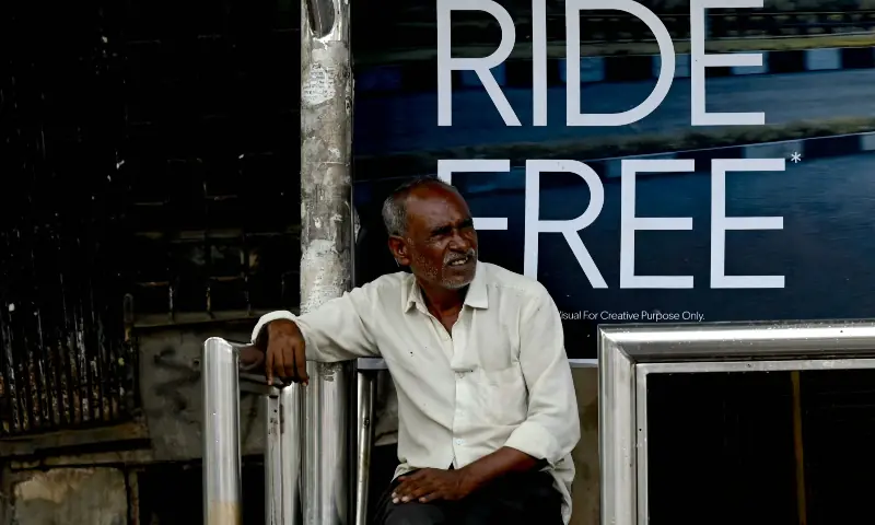 A commuter waits at a bus stop in Mumbai on Sept 3, 2026. &mdash; AFP