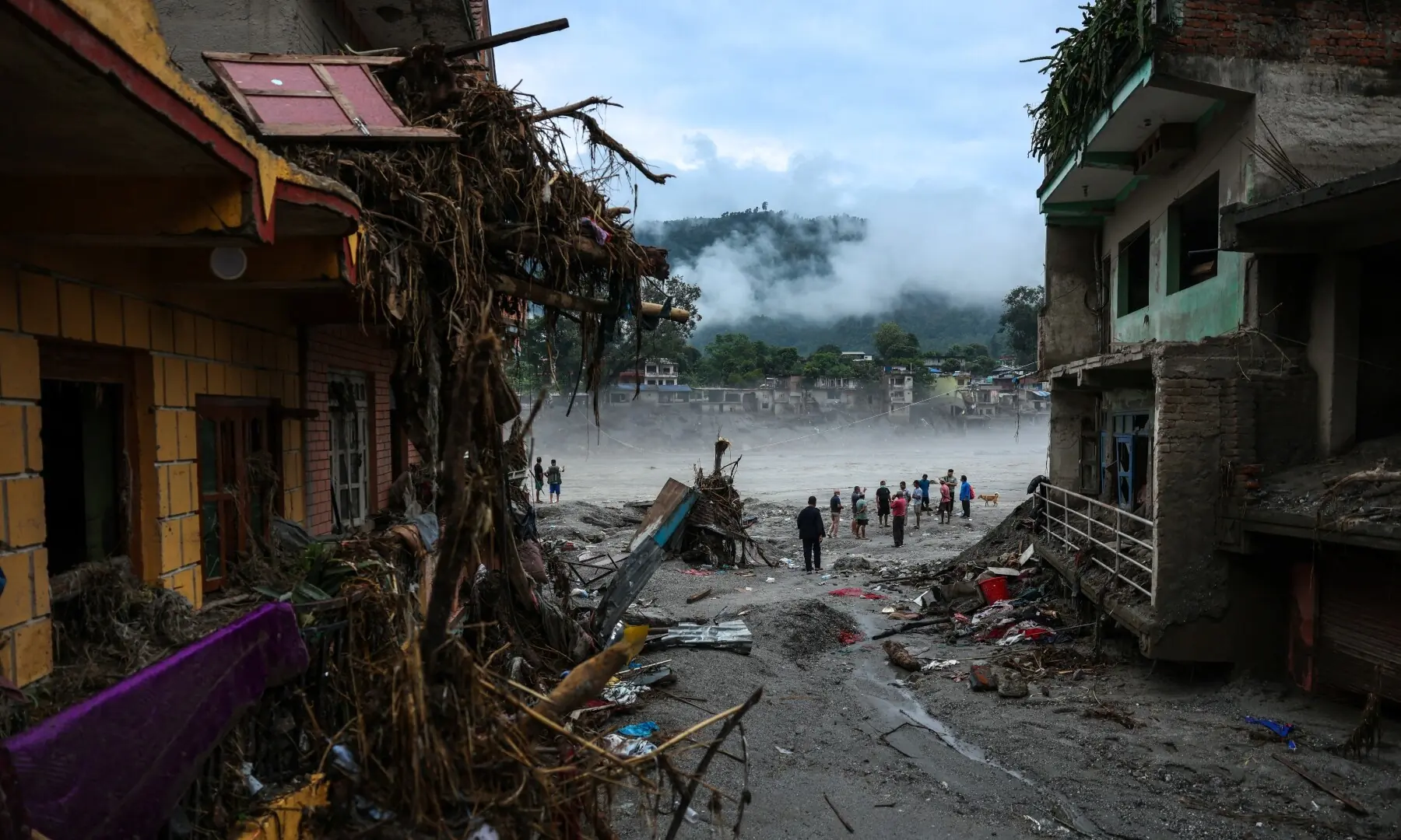 People stand next to damaged buildings following the deadly flash floods and a mudslide, in Devighat, Nuwakot district, Nepal on September 4, 2026. —Reuters People stand next to damaged buildings following the deadly flash floods and a mudslide, in Devighat, Nuwakot district, Nepal on September 4, 2026. —Reuters