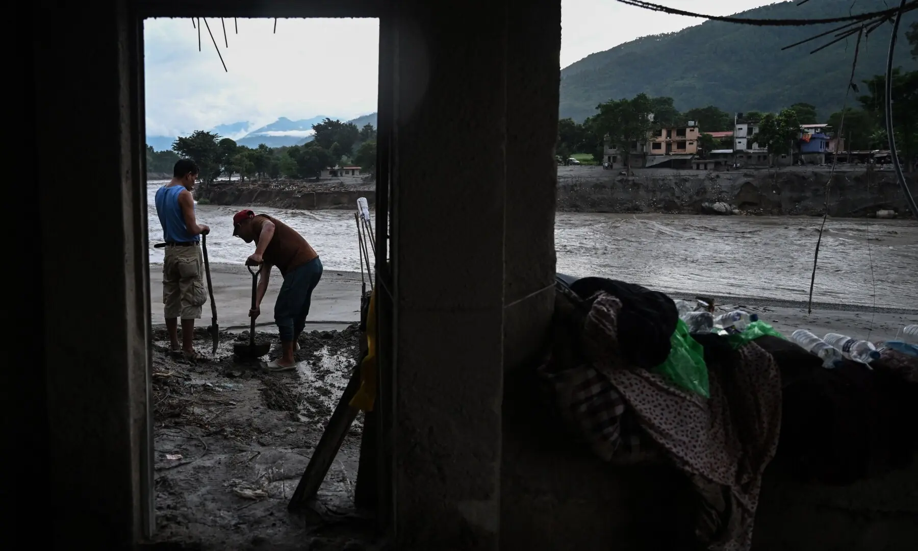 People clear sludge from a house in the aftermath of flash floods at Devighat in Nepal’s Nuwakot district on September 3, 2026. — AFP