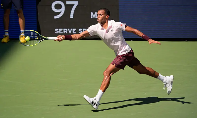 CANADA’S Felix Auger-Aliassime hits a return against Karen Khachanov of Russia during their US Open second-round match at the Flushing Meadows.—Reuters CANADA’S Felix Auger-Aliassime hits a return against Karen Khachanov of Russia during their US Open second-round match at the Flushing Meadows.—Reuters