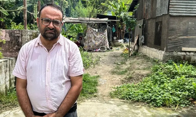 Rajendra Dawadi, 47, principal of the Trishuli Bazaar secondary school poses for a photograph in a garden next to his home in Nepal's Nuwakot District on September 4. &mdash; AFP
