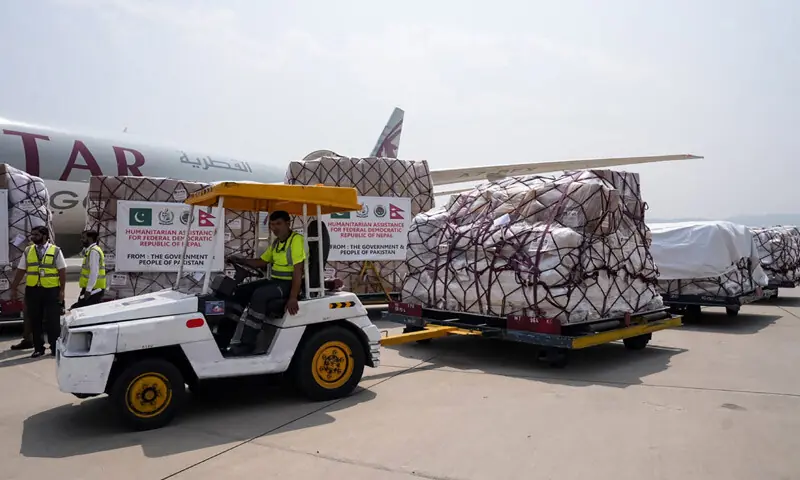 WORKERS load relief goods for flood victims in Nepal at Islamabad airport before their departure for Kathmandu.&mdash;AFP