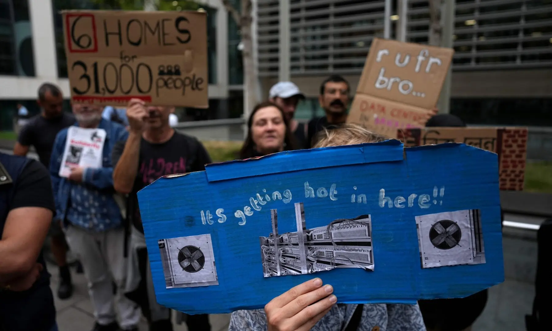 This photo taken on September 4, 2026 shows people holding placards against the approval of a data centre in the government’s redevelopment plans for Brick Lane, outside the Ministry of Housing offices in London. —AFP