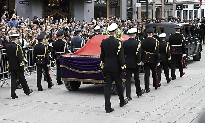 The casket of late King Harald V of Norway is carried amid an honour guard and spectators during a royal procession from the Royal Palace Chapel to the Cathedral in Oslo, Norway on September 9, 2026. &mdash; AFP