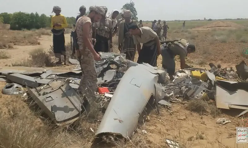 Fighters examine what Houthi-aligned media outlets claimed was the wreckage of a Saudi drone shot down over the Hajjah governorate.—AFP Fighters examine what Houthi-aligned media outlets claimed was the wreckage of a Saudi drone shot down over the Hajjah governorate.—AFP