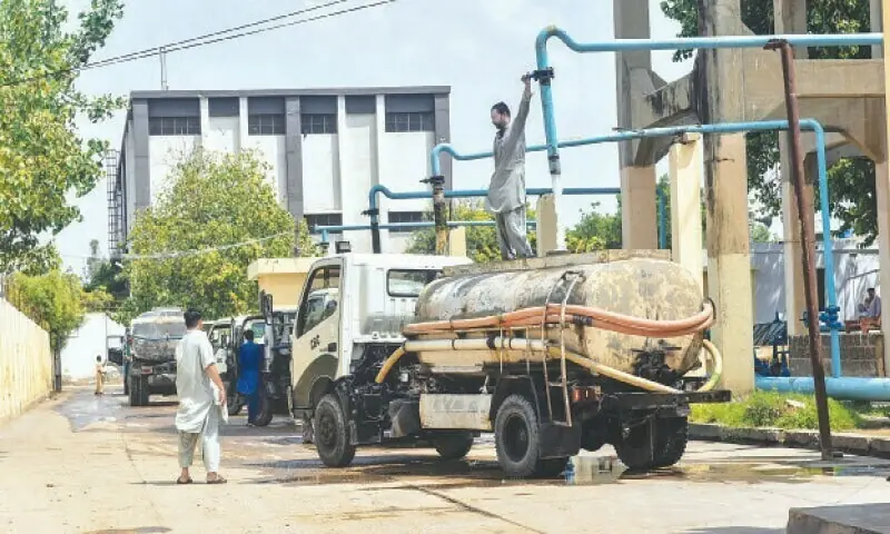 WATER tankers of the Cantonment Board Clifton are getting filled at an official hydrant — Fahim Siddiqi / White Star/File WATER tankers of the Cantonment Board Clifton are getting filled at an official hydrant — Fahim Siddiqi / White Star/File