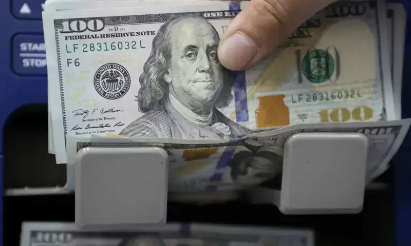 A man counts US dollar banknotes at a currency exchange shop. — Reuters/File A man counts US dollar banknotes at a currency exchange shop. — Reuters/File