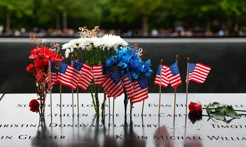 Flowers and flags are left at the memorial during the 25th anniversary commemoration of the September 11, 2001 attacks at the National September 11 Memorial in New York, the US on September 11, 2026. &mdash; AFP