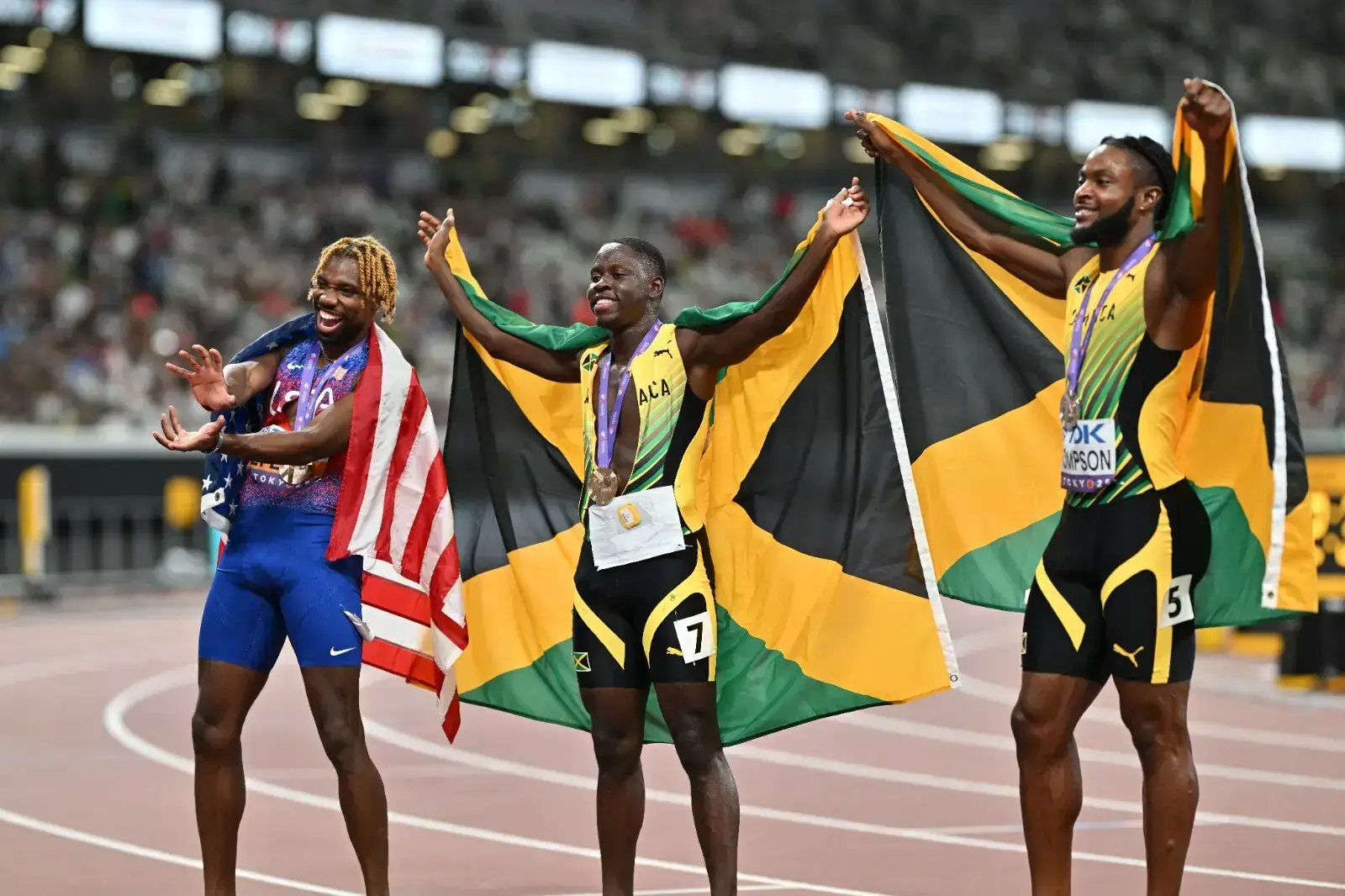 (L-R) Third-place US' athlete Noah Lyles, second-placed Jamaica's athlete Kishane Thompson, and winner Jamaica's athlete Oblique Seville celebrate with their medals after the men's 100m final during the World Athletics Championships in Tokyo on September 14, 2025. (Photo: AFP)