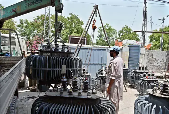 Wapda workers unload faulty transformers brought to the authority&rsquo;s Rawalpindi office for repair on Tuesday. &mdash; APP/File